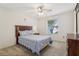 Bedroom featuring a wooden bed frame, soft carpet, and a window providing natural light at 17097 Se 96Th Chapelwood Cir, The Villages, FL 32162