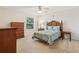 Cozy bedroom with carpet flooring, a ceiling fan, and natural light from the window at 17097 Se 96Th Chapelwood Cir, The Villages, FL 32162