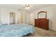 Bedroom featuring a light color scheme, carpet, and access to both a closet and the bathroom at 17097 Se 96Th Chapelwood Cir, The Villages, FL 32162