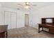 A bright bedroom with a ceiling fan, carpet flooring and closet at 17097 Se 96Th Chapelwood Cir, The Villages, FL 32162