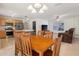 Dining area features wood table and chairs, with stainless steel appliances nearby at 17097 Se 96Th Chapelwood Cir, The Villages, FL 32162