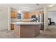 Kitchen featuring a central island, stainless steel refrigerator, and light wood cabinetry at 17097 Se 96Th Chapelwood Cir, The Villages, FL 32162