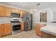 Kitchen featuring stainless steel appliances and light wood cabinets at 17097 Se 96Th Chapelwood Cir, The Villages, FL 32162