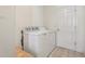 Brightly lit laundry room with tile floor and a white washing machine at 17097 Se 96Th Chapelwood Cir, The Villages, FL 32162