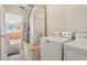 Laundry machines adjacent to utilities in a well-lit laundry area at 17097 Se 96Th Chapelwood Cir, The Villages, FL 32162