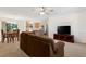 Open-concept living room flows into dining area, creating an inviting space at 17097 Se 96Th Chapelwood Cir, The Villages, FL 32162