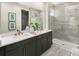 Modern bathroom with a double vanity, walk-in glass shower, and stylish tile flooring at 1969 Beach Ter, Celebration, FL 34747