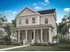 Inviting two-story home with a charming front porch and classic architectural details at 1969 Beach Ter, Celebration, FL 34747