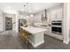 Stunning eat-in kitchen with a large center island, stainless steel appliances, and stylish pendant lighting at 1969 Beach Ter, Celebration, FL 34747