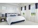 Serene bedroom with white wainscoting, plush bedding, and plenty of natural light at 1969 Beach Ter, Celebration, FL 34747