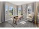 Well-lit home office with a modern desk, comfortable seating, and large windows at 1969 Beach Ter, Celebration, FL 34747