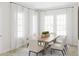Bright and airy dining room featuring a large wooden table and chairs, with natural light flooding in from large windows at 1993 Beach Ter, Celebration, FL 34747