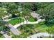 An aerial shot showcasing the house, with a winding driveway and lush green lawn at 202 Riverview Dr, Longwood, FL 32779