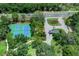 Overhead shot of tennis courts next to a road, surrounded by trees at 202 Riverview Dr, Longwood, FL 32779