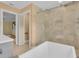 Bright bathroom showcasing a shower with glass doors and soaking tub at 202 Riverview Dr, Longwood, FL 32779