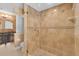 This shower features tan tiles and a glass door with bronze hardware at 202 Riverview Dr, Longwood, FL 32779