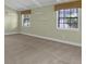 Neutral bedroom has a carpeted floor and two windows for natural light at 202 Riverview Dr, Longwood, FL 32779