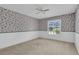 Bedroom featuring patterned wallpaper, a ceiling fan, and a bright window at 202 Riverview Dr, Longwood, FL 32779