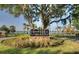 Community sign surrounded by meticulously manicured landscaping and trees, showcasing a well-maintained entrance at 202 Riverview Dr, Longwood, FL 32779