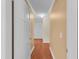 Hallway featuring wood floors and neutral walls with white trim at 202 Riverview Dr, Longwood, FL 32779