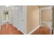 Long hallway with hardwood floors and multiple doorways at 202 Riverview Dr, Longwood, FL 32779