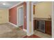 Hallway with tile floor leads to a bar area with granite countertops and wine refrigerator at 202 Riverview Dr, Longwood, FL 32779