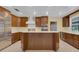 Spacious kitchen with custom wood cabinets, stainless steel appliances, and center island for meal prep at 202 Riverview Dr, Longwood, FL 32779