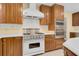 Modern kitchen with Viking range, custom cabinets, and a stylish hood for cooking enthusiasts at 202 Riverview Dr, Longwood, FL 32779