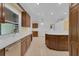 Bright kitchen with stainless steel dishwasher and sink, custom wood cabinets, and breakfast bar at 202 Riverview Dr, Longwood, FL 32779