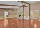 Spacious living room features a stone fireplace, beamed ceilings, and hardwood floors at 202 Riverview Dr, Longwood, FL 32779