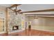 Bright living room with stone fireplace, hardwood floors, and beamed ceiling at 202 Riverview Dr, Longwood, FL 32779