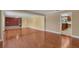 Open floorplan showcasing the hardwood floors and neutral color scheme. Includes view to the kitchen at 202 Riverview Dr, Longwood, FL 32779