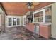 A fully-equipped outdoor kitchen featuring a built-in grill, refrigerator, and sink with tile floors and ceiling fan at 202 Riverview Dr, Longwood, FL 32779