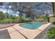 The covered pool area is surrounded by lush landscaping and greenery at 202 Riverview Dr, Longwood, FL 32779