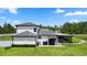 A well-maintained backyard with a covered patio, privacy fence, and manicured landscaping at 20796 Quinn St, Orlando, FL 32833