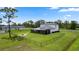A spacious fenced backyard featuring a covered patio and fire pit, ideal for outdoor enjoyment at 20796 Quinn St, Orlando, FL 32833