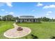Expansive backyard with a fire pit area, lush lawn, and a view of the home's back exterior at 20796 Quinn St, Orlando, FL 32833