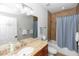 Well-lit bathroom with a granite-topped vanity, shower-tub combo, and neutral tile, offering a clean aesthetic at 20796 Quinn St, Orlando, FL 32833