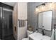 Modern bathroom featuring black and white tile, a glass enclosed shower, and sleek fixtures at 20796 Quinn St, Orlando, FL 32833