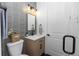 Stylish bathroom featuring gray tile, a modern vanity, sleek lighting, and glass enclosed shower at 20796 Quinn St, Orlando, FL 32833