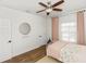 Charming bedroom with modern decor, hardwood floors, ceiling fan, and plenty of natural light at 20796 Quinn St, Orlando, FL 32833