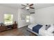 Nicely appointed bedroom features hardwood floors, a ceiling fan, and two large windows at 20796 Quinn St, Orlando, FL 32833