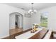Bright dining room with farmhouse-style table and chairs, and a window overlooking the yard at 20796 Quinn St, Orlando, FL 32833