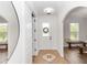 Welcoming home entryway with tiled floor, coat closet, and arched doorway to the dining room at 20796 Quinn St, Orlando, FL 32833