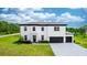 Stunning two-story home featuring a three-car garage and meticulously landscaped front yard at 20796 Quinn St, Orlando, FL 32833