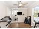 Cozy exercise room with a treadmill, free weights, and mirrored accent wall at 20796 Quinn St, Orlando, FL 32833