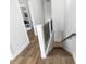 Upstairs hallway features hardwood floors, a wrought iron railing, and an open view down the stairs at 20796 Quinn St, Orlando, FL 32833