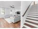 Bright living room showcases hardwood floors, a ceiling fan, and staircase with wood and white trim at 20796 Quinn St, Orlando, FL 32833