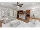 Inviting living space open to kitchen, featuring modern furniture, hardwood floors, and natural light at 20796 Quinn St, Orlando, FL 32833