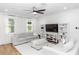 Bright living room with cozy seating, stylish shelving, and elegant sheer curtains at 20796 Quinn St, Orlando, FL 32833
